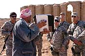Dhief Muhsen, curator for the historical sites at Ur, shows Soldiers from the 449th Aviation Support Battalion, 36th Combat Aviation Brigade, how the city used to look several thousand years ago. (U.S. Army photo by Staff Sgt. Lorin T. Smith)
