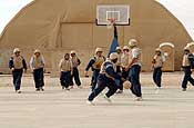 Members of the engineering and installation teams from five different National Guard units play basketball on Ali Base, Iraq, Feb. 18, 2006. DoD photo by Staff Sgt. Valerie Smith, U.S. Air Force. (Photo by SSgt Valerie Smith)