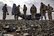 U.S. Army personnel wait in line to board a C-130H2 aircraft at a dirtstrip on Bagram Air Base, Afghanistan, March 8, 2006, headed to Forward Operations Base Salearno, Afghanistan. The aircraft and crew are assigned to the 185th Airlift Squadron, Will Rogers World Airport, Oklahoma Air National Guard and are deployed to the 774th Expeditionary Airlift Squadron, Bagram Air Base. (U.S. Air Force photo by Master Sgt. Lance Cheung)