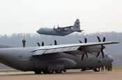 The last Air National Guard's EC-130E Commando Solo takes off above a C-130 Hercules for the final time at the Harrisburg International Airport on Monday, April 3, 2006. The 