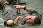 Tech. Sgt. Dana Vaughan pulls himself across a cold Vermont pond on Thursday, June 8, 2006. Sergeant Vaughan is attending a two-week mountaineer training course at the Vermont National Guard Army Mountain Warfare School in Jericho, Vt. He is a pararescueman from Nellis Air Force, Base, Nev. (Air National Guard photo/Master Sgt. Rob Trubia)