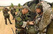 U.S. Army National Guardsman Staff Sgt. Ken Hill, from 116th Air Support Operations Squadron out of Fort Lewis, Wash., conducts a mandatory pre-inspection on Spc. Matthew O'Neil, from Aerial Delivery out of Fort Lewis, Wash., at Fort McCoy, Wis., July 21, 2006, during exercise Patriot 2006. Patriot, the largest joint, annual exercise held in the United States, increases the war-fighting capabilities of the U.S. Air Force and Army National Guard, reserve, and active components as well as interoperability with the participating nations of Canada, United Kingdom, and the Netherlands. (U.S. Air Force photo by Master Sgt. Patrick J. Cashin)
