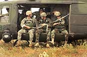 U.S. Army Staff Sgt. Brian Harris checks U.S. Army National Guard paratroopers are secure before the a Canadian CH-146 Griffon helicopter takes off from Fort McCoy, Wis., July 21, 2006, during exercise Patriot 2006. Patriot, the largest joint, annual exercise held in the United States, increases the war-fighting capabilities of the U.S. Air Force and Army National Guard, reserve, and active components as well as interoperability with the participating nations of Canada, United Kingdom, and the Netherlands. The paratroopers are from 2nd Battalion, 20th Special Forces Group out of Chicago, Ill., and 116th Air Support Operations Squadron out of Fort Lewis, Wash. (U.S. Air Force photo by Master Sgt. Patrick J. Cashin)
