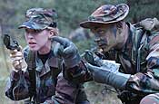 U.S. Army Pfc. Dave Grever shows U.S. Air Force Tech. Sgt. Cindy Beaird how to find an azimuth during a combat search and air rescue class held at Fort McCoy, Wis., July 21, 2006, during exercise Patriot 2006. Patriot, the largest annual joint exercise held in the United States, increases the war-fighting capabilities of the U.S. Air Force and Army National Guard, reserve, and active duty components, as well as interoperability with the participating nations of Canada, United Kingdom, and the Netherlands. Grever is an air crew life support instructor assigned to the 164th Airlift Wing, Air National Guard, Memphis, Tenn.; Beaird is an information management functional manager with the 126th Air National Guard, Shiloh, Ill. DoD photo by Master Sgt. Robert A. Whitehead, U.S. Air Force.