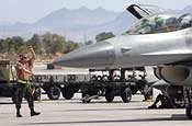 Getting ready for Red Flag - Senior Airman Brent Bott marshals an F-16 Fighting Falcon for a mission at Red Flag 06-02 at Nellis Air Force Base, Nev., on Aug. 8. Airman Bott is a crew chief with the Iowa Air National Guard's 132nd Fighter Wing in Des Moines. (U.S. Air Force photo/Tech.Sgt. Bob Sommer)