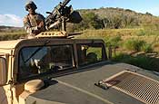 Pfc. Brandon Ross, of E Company, 629th Military Intelligence Battalion, Maryland Army National Guard, provides overwatch security at a checkpoint near the Joint Task Force Guantanamo detention center at Naval Base Guantanamo Bay, Friday, Nov. 17, 2006. The company's main missions as part of the task force include external perimeter security as well as acting as a quick reaction force should something happen inside the detention center. (Photo by Staff Sgt. Jon Soucy, National Guard Bureau)
