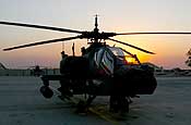 A 36th Combat Aviation Brigade AH-64 Apache gallantly sits while the setting sun shines through its windshield on LSA Anaconda, Iraq. (U.S. Army photo by Capt. Randall Stillinger)
