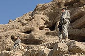 U.S. Army Soldiers from 1st Platoon, Bravo Company, 1st Battalion, 102nd Infantry Regiment, Connecticut National Guard look down the side of hill outside a cave near the village of Showki in the Kabisa province of Afghanistan Jan. 3, 2007. (U.S. Army pho to by Sgt. Isaac A. Graham)