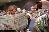 U.S. Army Spc. Rodrigo Miranda reads a newspaper prior to boarding an aircraft at Charleston Air Force Base, S.C., Feb. 1, 2007, to be transported to Camp Shelby, Miss., for training in preparation for an 18-month deployment to Afghanistan. Miranda is wi th the South Carolina Army National Guard. (U.S. Air Force photo by Senior Airman Jason Robertson)