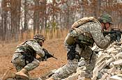 Exercise Granite Triangle - Pfc. Kevin Wheeler, left, and Sgt. John Boudreau, both assigned to the 237th Military Police Company, move from cover while assaulting an objective as a team during Exercise Granite Triangle at Fort Pickett, Va.