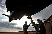 Exercise Granite Triangle - U.S. Navy Petty Officer 1st Class Adrian Cristea, center, a crew chief with the Navy's Helicopter Mine Countermeasures Squadron 14, assists Spc. Justin McNeff, left, and Spc. Adam Haggett, both with C Company, 3rd Battalion, 172nd Infantry Regiment (Mountain) with slingloading a humvee to a Navy MH-53E Sea Dragon helicopter during Exercise Granite Triangle at Fort Pickett, Va., Thursday, Feb. 22, 2007