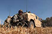 Exercise Granite Triangle - Spc. Peter Miner, of the 237th Military Police Company, pulls security at a landing zone in preparation for Soldiers from the 1159th Medical Company (Air Ambulance) to pick up a simulated casuality during Exercise Granite Triangle at Fort Pickett, Va.