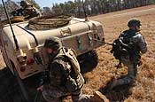 Exercise Granite Triangle - Spc. Peter Miner, of the 237th Military Police Company, pulls security at a landing zone in preparation for Soldiers from the 1159th Medical Company (Air Ambulance) to pick up a simulated casuality during Exercise Granite Triangle at Fort Pickett, Va.