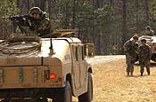 Exercise Granite Triangle - A squad of Soldiers from the 237th Military Police Company consolidate their forces prior to moving out to their next objective during Exercise Granite Triangle at Fort Pickett, Va.