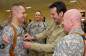 1st Lt. Matthew Majeski of Cedar Rapids, Iowa, Headquarters and Headquarters Company, 1st Brigade Combat Team, 34th Infantry Division, is promoted to captain by Minnesota Gov. Tim Pawlenty Wednesday, March 7 as Lt. Gen. H. Steven Blum, Chief of the National Guard Bureau, watches at the Camp Adder Chapel in Iraq. Capt. Brad Mikkelsen of Savage, Minn., also of the 1/34 BCT, is in the center. (Photo by Sgt. 1st Class Clinton Wood, 1/34 BCT PAO)