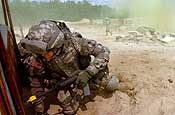  Chief Warrant Officer Walter Rose, from Headquarters and Headquarters Company, 58th Infantry Brigade Combat Team, peers around an obstacle during training on individual movement techniques at Fort Dix, N.J., Sunday, May 6, 2007. The 58th IBCT is currently going through training at Fort Dix in preparation for deployment to Iraq. (U.S. Army photo by Staff Sgt. Jon Soucy) (Released).