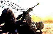 Maj. Ted Cusick, from Headquarters and Headquarters Company, 58th Infantry Brigade Combat Team, crawls under concertina wire while negotiating an obstacle during training on individual movement techniques at Fort Dix, N.J., Sunday, May 6, 2007. The 58th IBCT is currently going through training at Fort Dix in preparation for deployment to Iraq. (U.S. Army photo by Staff Sgt. Jon Soucy) (Released)