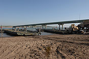 Soldiers from South Dakota Army National Guard's 200th Engineer Company loaded military vehicles and Soldiers from the 1133rd Transportation Battalion, Iowa Army National Guard, onto five float ribbon-bridge rafts and transported them across the water on Sunday, June 10, at the Missouri River in Chamberlain. The units being shuttled across the river will participate in the 2007 Joint Thunder Exercise. Army National Guard photo by Sgt. 1st Class Donald Matthews.