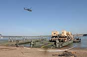 Soldiers from South Dakota Army National Guard's 200th Engineer Company loaded military vehicles and Soldiers from the 1133rd Transportation Battalion, Iowa Army National Guard, onto five float ribbon-bridge rafts and transported them across the water on Sunday, June 10, at the Missouri River in Chamberlain. Army National Guard photo by Sgt. 1st Class Donald Matthews.