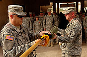 Command Sgt. Maj. Brian Sann, left, brigade sergeant major for the 58th Brigade Combat Team, left, and Col. Sean Casey, commander of the 58th BCT, uncase the unit's colors during a transfer of authority ceremony in which the 58th BCT assumed responsibility for garrison operations of Victory Base Complex, Iraq, from the 38th Division Support Command, Tuesday, July 10, 2007. The 58th BCT will be responsible for all daily operations on VBC.(U.S. Army photo by Staff Sgt. Jon Soucy)