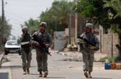 Soldiers from Company A, 1st Battalion, 149th Infantry Regiment scan their surroundings as they patrol through the Al Furat Section of Baghdad, Monday, Aug. 20, 2007. The unit conducts patrols through the area several times each day and have built a relationship with those who live in the area and through those relationships have helped rebuild marketplaces and other key places in the area. (U.S. Army photo by Staff Sgt. Jon Soucy) (Released)