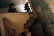Soldiers from Company A, 1st Battalion, 149th Infantry Regiment, search a building for weapons caches as they patrol through the Al Furat Section of Baghdad, Monday, Aug. 20, 2007. The unit conducts patrols through the area several times each day and have built a relationship with those who live in the area and through those relationships have helped rebuild marketplaces and other key places in the area. (U.S. Army photo by Staff Sgt. Jon Soucy) (Released)