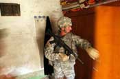 Sgt. 1st Class Michael Dobbs, a platoon sergeant with Company A, 1st Battalion, 149th Infantry Regiment, checks a cabinet in a home in the Al Furat section of Baghdad for illegal weapons during a presence patrol through the area, Monday, Aug. 20, 2007. The unit conducts patrols through the area several times each day and have built a relationship with those who live in the area and through those relationships have helped rebuild marketplaces and other key places in the area. (U.S. Army photo by Staff Sgt. Jon Soucy) (Released)