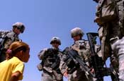 Soldiers from Company A, 1st Battalion, 149th Infantry Regiment, joke with a local Iraqi girl while on patrol in the Al Furat section of Baghdad, Thursday, Aug. 29, 2007. Soldiers from the unit have been working with local officials to assist with rebuilding schools and other facilities in the area. (U.S. Army photo by Staff Sgt. Jon Soucy) (Released)