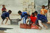 Local children play with plastic crates in the streets of the Al Furat section of Baghdad, Thursday, Aug. 30, 2007 (U.S. Army photo by Staff Sgt. Jon Soucy) (Released)