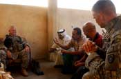 Lt. Col. John Luttrell, left, commander of 1st Battalion, 149th Infantry Regiment, talks with Ahmed Selman Abbas, gesturing with hand, chairman of the Al Furat Council, during a weekly council meeting in the Al Furat section of Baghdad, Friday, Aug. 31, 2007. The unit has been working with the council to help rebuild infrastructure, schools and marketplaces in the Al Furat section. (U.S. Army photo by Staff Sgt. Jon Soucy) (Released)