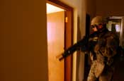  Spc. Baylen Brock, an infantryman assigned to Company A, 1st Battalion, 149th Infantry Regiment, clears a room in a building in the Al Furat section of Baghdad, Thursday, Sept. 6, 2007. Soldiers from the unit were clearing the building after receiving reports of possible insugent activity in the building. The building was empty. (U.S. Army photo by Staff Sgt. Jon Soucy) (Released)