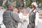 BAGHLAN-I-JADEED, Afghanistan - Master Sgt. Phillip Lakner of Rapid City, S.D., and a member of the South Dakota National Guard’s Embedded Training Team “Coyote One,” attempts to speak Dari to a local man during a foot patrol in Baghlan-i-Jadeed, Afghanistan, in July. (National Guard courtesy photo)(RELEASED)