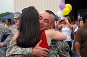 CARVILLE, La. – A couple embraces each other after spending a year apart due to the Soldiers deployment to Operation Iraqi Freedom supporting the 769th Engineer Battalion out of Baton Rouge . The couple was reunited at the Baton Rouge Metropolitan Airport on Mon., July 14. (U.S. Army Photo by Staff Sgt. Lacy Brown, 415th Military Intelligence Battalion Unit Public Affairs Representative)