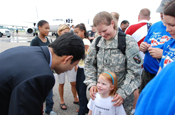 CARVILLE, La. – Governor Bobby Jindal shares in the excitement of the reunited 1st Lt. Danielle E. Hardee and her daughter Rebecca E. Hardee at the Baton Rouge Metropolitan Airport on Mon., July 14 for the redeployment of the 769th Engineer Battalion from Iraq. Hardee and her daughter are both residents of Prairieville, La. (U.S. Army Photo by Staff Sgt. Lacy Brown, 415th Military Intelligence Battalion Unit Public Affairs Representative)