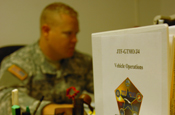 Guantanamo Bay, Cuba. - 1st Lt. Shane T. Lauritzen, a New Mexico Army National Guardsman with Joint Task Force Guantanamo's Logistics Directorate Motor Pool Detachment looks over vehicle contracts as part of his daily routine, July 8, 2008. (JTF Guantanamo photo by Navy Petty Officer 3rd Class Kleynia R. McKnight) 