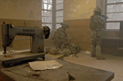 A Soldier evaluates a casualty as another pulls security at a window at in old historic building at the Muscatatuck Urban Training Center in Indiana during a Special Forces training program. (U.S. Army photo by Spc. John Crosby)