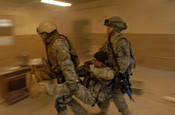 Soldiers 'buddy carry' a wounded Soldier to evacuate him after an ambush during a six-day training course given by Special Forces members, at the Muscatatuck Urban Training Center in Indiana. (U.S. Army photo by Spc. John Crosby)