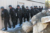 Members of the Old Colony Regional Special Operations Group prepare to search and clear a building at the Maj. Jeffery R. Calero Military Operations in Urban Terrain training site on Camp Edwards, Mass., Jan. 29, 2009. The group trained at the MOUT training site to practice team movement techniques and room clearing procedures. The group is made up of law enforcement officers from eight agencies and serves high-risk warrants in 18 communities. (U.S. Army photo by Sgt. James C. Lally)