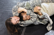  A Provincial Reconstruction Team Soldier puts the squeeze on her battle buddy during the combatives portion of their training. (U.S. Army photo by Spc. Jeff Field)