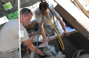  Air Force Senior Airman John McClung, a heating, ventilation and air conditioning technician with the 474th Expeditionary Civil Engineering Squadron, repairs an air conditioning unit at Camp Justice, May 22, 2009. JTF Guantanamo photo by Army Pfc. Christopher Vann)