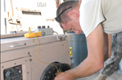   Senior Airman John McClung, a heating, ventilation and air conditioning technician with the 474th Expeditionary Civil Engineering Squadron, repairs an air conditioning unit at Camp Justice, May 22, 2009. The 474th ECES supports the Joint Task Force Guantanamo by maintaining the Expeditionary Legal Complex and Camp Justice facilities and infrastructure. (JTF Guantanamo photo by Army Pfc. Christopher Vann)