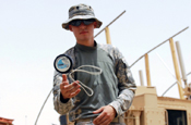 BAGHDAD –Spc. Michael Cox of Hermitage, Ark., passes time during his break outside of Salam Palace in Baghdad by perfecting yo-yo tricks, June 6. The 225th Engineer Brigade personnel security detachment member said that although he was accomplished with the yo-yo before deploying, he has been able to add tricks to his repertoire. (U.S. Army Photo by Sgt. Rebekah Malone, 225 Eng. Bde.,1st Cav. Div., MND-B)