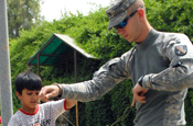 BAGHDAD – Ali, a young Iraqi, and Louisiana National Guardsman Spc. Joshua Brister of Dry Prong, La., trade yo-yo tricks, June 6. The 225th Engineer Brigade personnel security detachment Soldier was waiting in front of Salam Palace playing with the yo-yo when the Iraqi boy came to join the fun. Brister gave the nearly $50 yo-yo to the Iraqi boy to take home. (U.S. Army Photo by Scott Flenner, 225 Eng. Bde., 1st Cav. Div., MND-B)