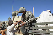 Capt. Jason K. Piercy, 147th Field Artillery, South Dakota Army National Guard, and fellow Soldiers participated in a health assistance visit on Wednesday, Oct. 4, in the village of Robat, Afghanistan. The unit handed out food, cooking stoves, blankets, wheel barrows and first-aid supplies. The unit is also building a boys and girls school in the village. (Army photo by 1st Lt. Randy Lynch)