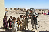 Capt. Jason K. Piercy, 147th Field Artillery, South Dakota Army National Guard, poses with local children during a health assistance visit on Wednesday, Oct. 4, in the village of Robat, Afghanistan. (Army photo by 1st Lt. Randy Lynch)