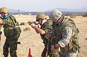 KRIVOLAK, Macedonia - A Vermont National Guardsman observes a Macedonian military policeman during the rifle marksmanship training portion of Operation Rising Phalanx, which took place here Sept. 9-22, 2006. The U.S. European Command State Partnership Program sponsored field exercise culminated a 10-month small unit exchange to train Macedonian Army military police platoons to take part in international peacekeeping missions. The State Partnership Program, which originated in 1993, links a National Guard State with a partner nation in support of EUCOM’s Theater Security Cooperation objectives. There are currently 24 partnerships within the EUCOM area of responsibility. (Department of Defense photo) 