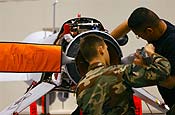 Predator Unmanned Aerial Vehicle crews from the California Air National Guard performing maintenance at the Creech AFB, Nevada training site. The Predator provides armed battlefield reconnaissance and support for ground assets in the global war on terror. (USAF Photo/Master Sgt. Gerold O. Gamble)