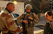 Sgt. Robert Kay (center) speaks with an Iraqi policeman (left) about the conditions and progress at the Al Jamouri Hospital Police Station in Mosul, Jan. 25. The National Guardsman is a member of the 144th Military Police Company out of Michigan. (Photo by Staff Sgt. Samantha Stryker, 5th Mobile Public Affairs Detachment, Tikrit)