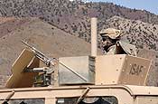 Spc. Victor Piacente of 1st Battalion, 102nd Infantry Regiment of the Connecticut National Guard, and part of the Gardez Provincial Reconstruction Team, scans his sector while his convoy stops for a break on an extended patrol in the Gardez Province of Afghanistan. (U.S. Army photo by Staff Sgt. Michael Bracken.)