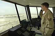  Baghdad, Iraq - U.S. Air National Guardsman Staff Sgt. William Ferguson (seated) deployed from Casper, Wy., manages aircraft on the international ramp at Baghdad International Airport (BIAP) on June 2, 2007. Staff Sgt. Ferguson is one of the several U.S. Air Force air traffic controllers manning the control tower around the clock to manage the ever increasing load of air traffic coming into BIAP. The Air Force members not only control the 14,000 flights per month currently flying into and out of the airport, but they are also working to improve the infrastructure and technology in the control tower.